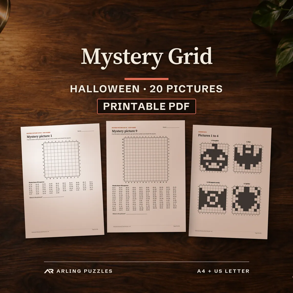 Halloween Mystery Grid, 20 pictures, printable PDF. Real pages on a desk: mystery picture 1 on a 10 by 10 grid, mystery picture 9 on a 15 by 15 grid and an answer key page.