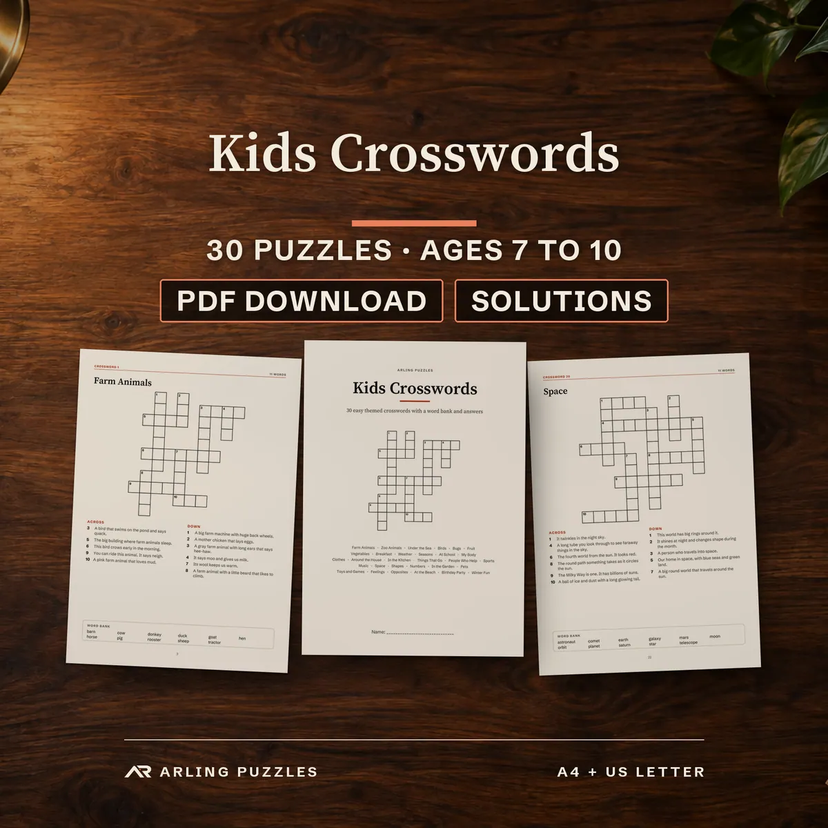Kids Crosswords printable book, 30 themed crosswords for ages 7 to 10 on a teacher desk